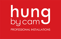 Hung By Cam. Professional wall hanging and signage installation service.